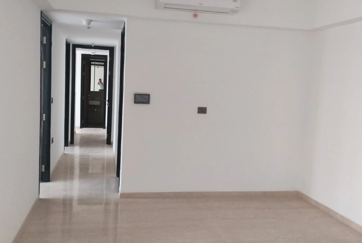 Spacious living and dining area with marble flooring, split AC and passage to bedrooms in 3 BHK at Lodha Park Tower Adrina, Worli
