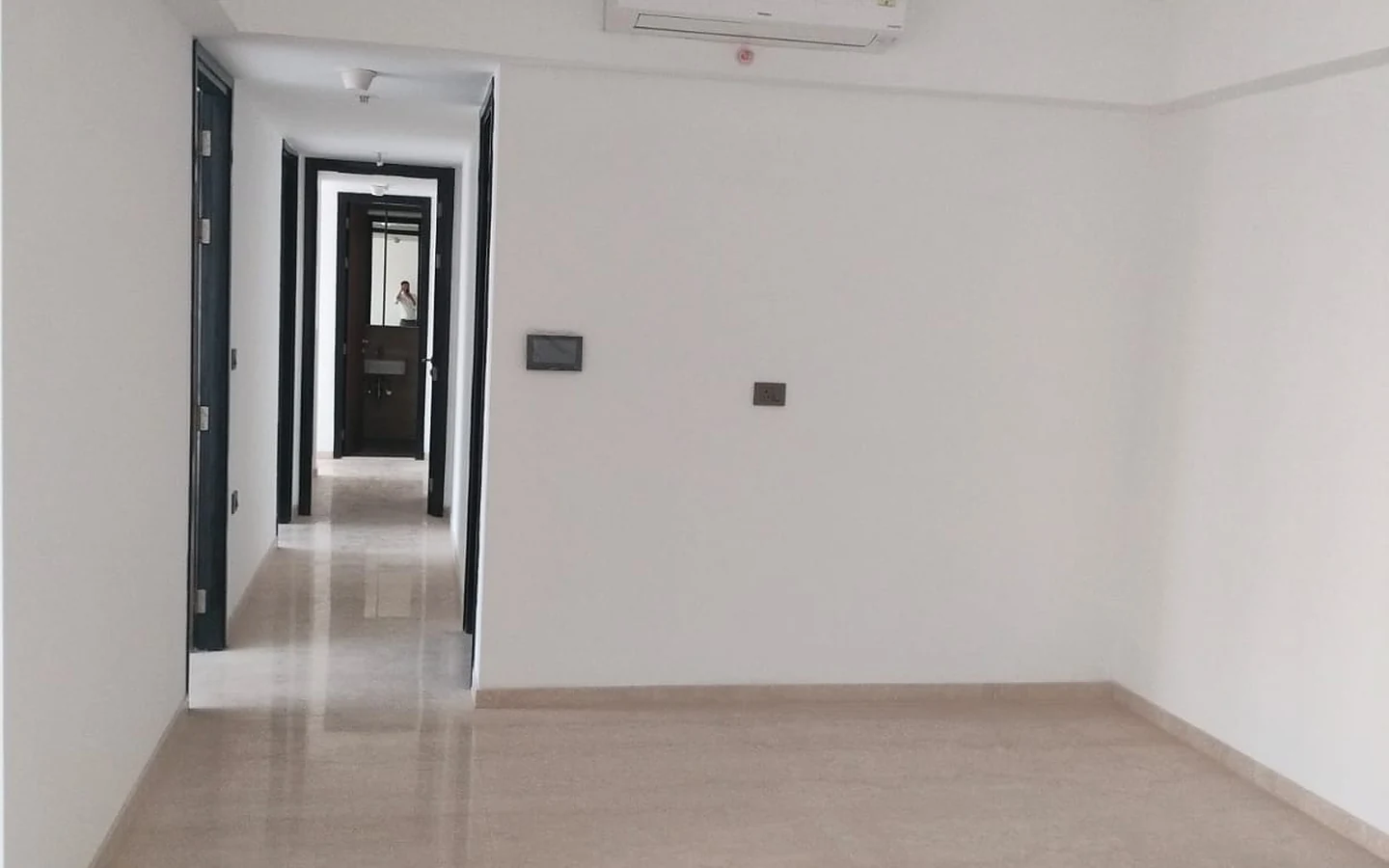 Spacious living and dining area with marble flooring, split AC and passage to bedrooms in 3 BHK at Lodha Park Tower Adrina, Worli