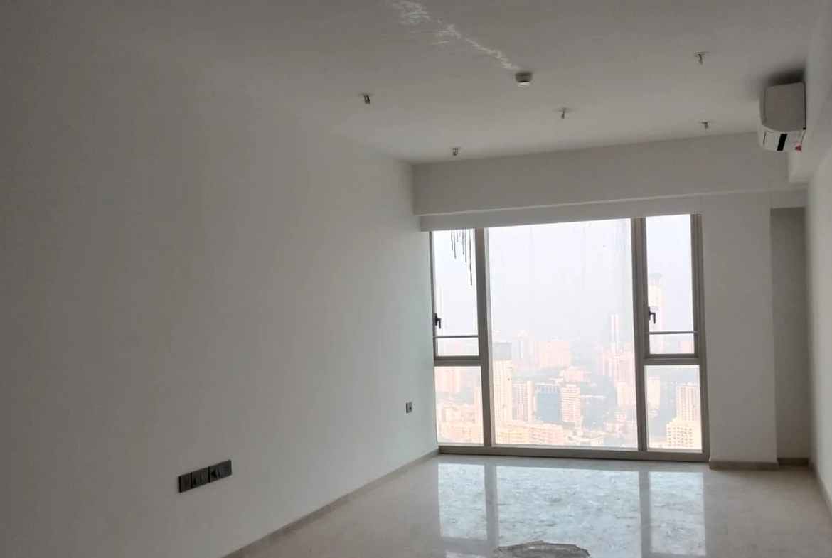 Living room with floor-to-ceiling window, Italian marble flooring and Mumbai city view in 3 BHK for rent at Lodha Park Tower Adrina, Worli