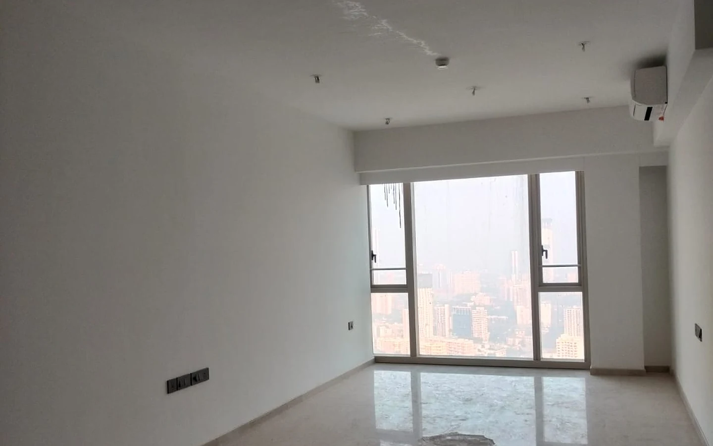 Living room with floor-to-ceiling window, Italian marble flooring and Mumbai city view in 3 BHK for rent at Lodha Park Tower Adrina, Worli