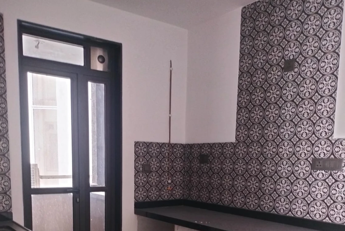 Kitchen with black granite counters, patterned tile backsplash and utility balcony door in 3 BHK at Lodha Park Tower Adrina, Worli