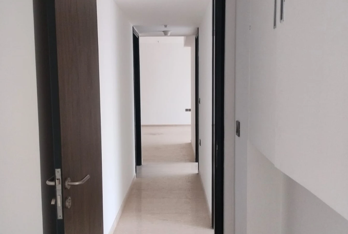 Passage leading to the bedrooms with marble flooring and wooden doors in 3 BHK at Lodha Park Tower Adrina, Worli