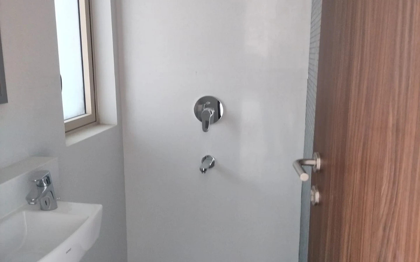Bathroom with rain shower, wall-mounted basin and window in 3 BHK at Lodha Park Tower Adrina, Worli
