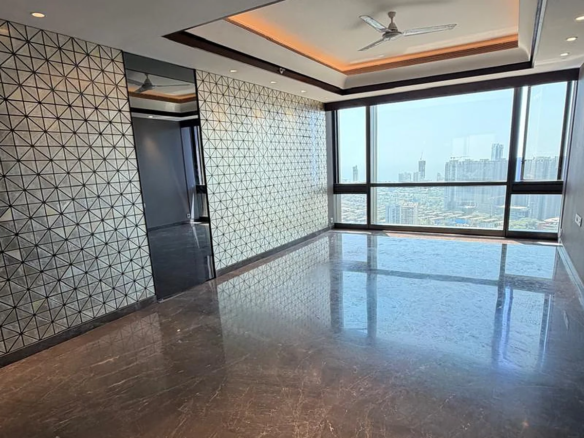 Living room with geometric mirror feature wall, cove-lit tray ceiling, Italian marble flooring and city view windows in 4 BHK at Lodha Trump Tower, Worli
