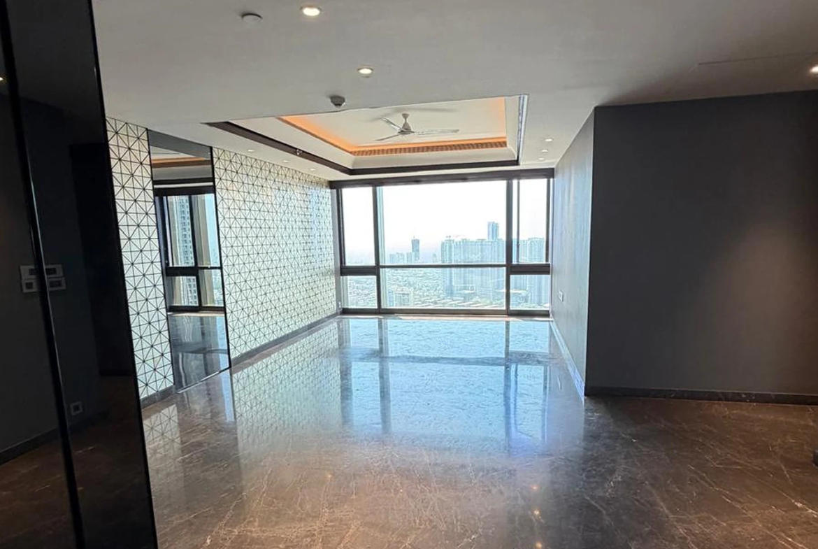 Open living and dining area with marble flooring and floor-to-ceiling windows in 4 BHK for sale at Lodha Trump Tower, Worli