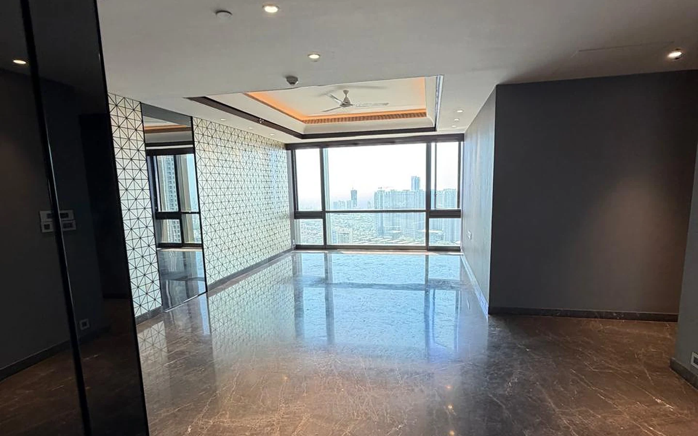 Lodha Trump Tower 4 BHK for Sale – Living and Dining Area Open living and dining area with marble flooring and floor-to-ceiling windows in 4 BHK for sale at Lodha Trump Tower, Worli