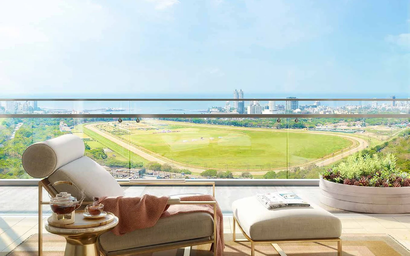 Residence balcony with lounger overlooking Mahalaxmi Racecourse and the sea at Piramal Mahalaxmi, South Mumbai