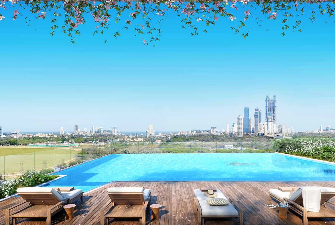 Infinity-edge swimming pool with sun deck and racecourse and city view at Piramal Mahalaxmi, South Mumbai