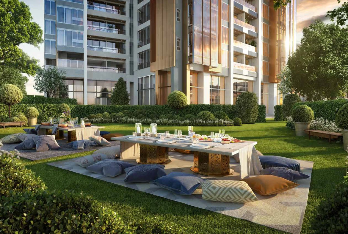 Landscaped grand lawn with outdoor dining and lounge seating at Piramal Mahalaxmi, South Mumbai