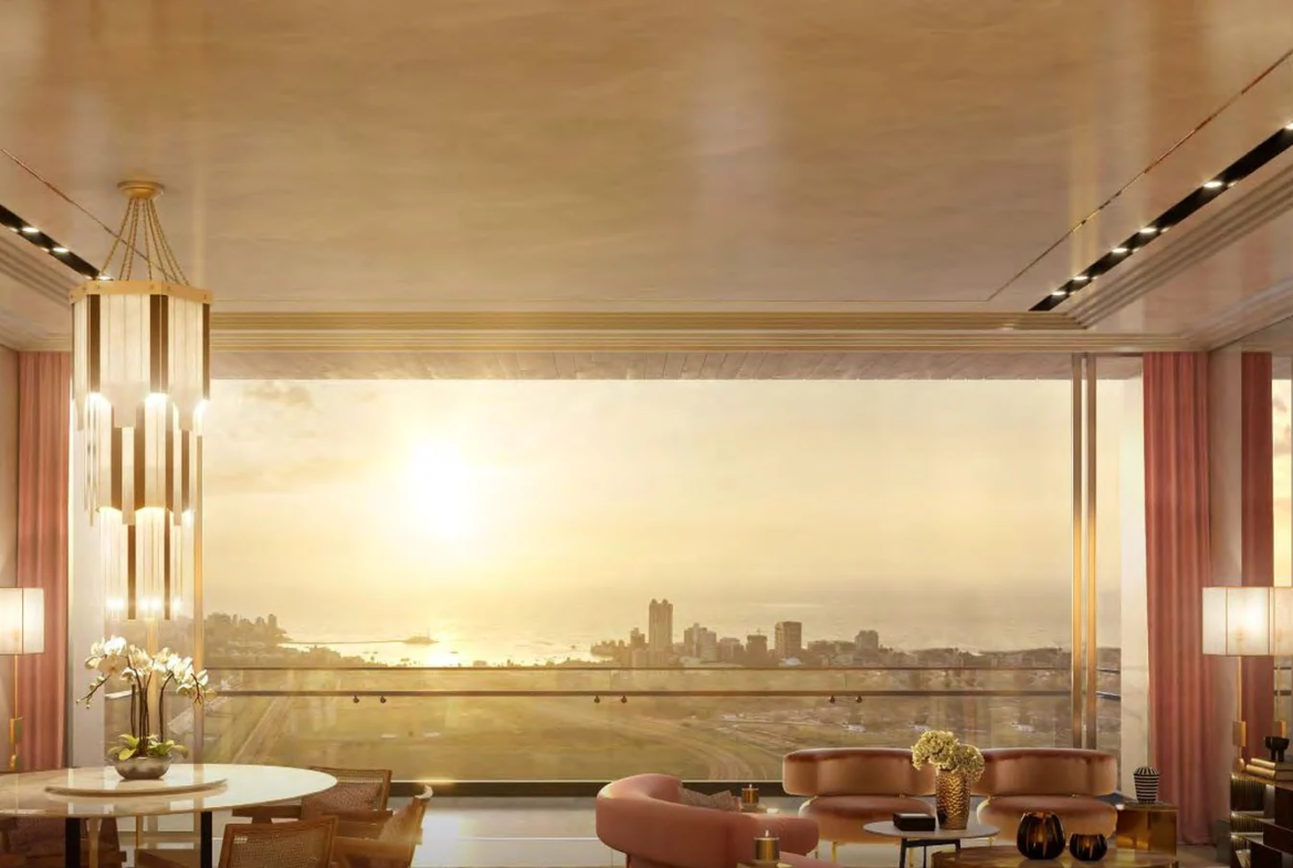 Sample living room with full-width windows overlooking the sea at sunset at Piramal Mahalaxmi, South Mumbai