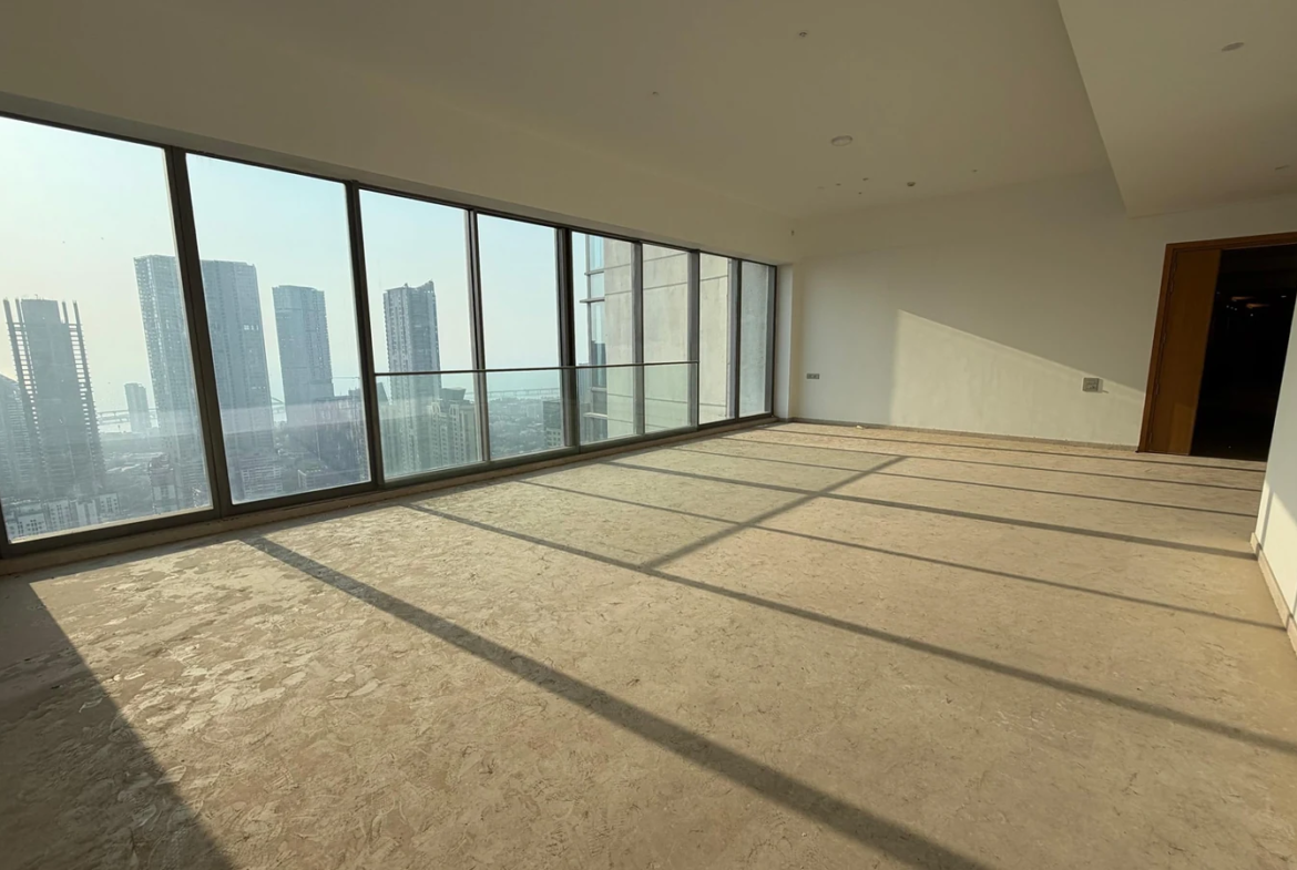 Living room with panoramic glass windows overlooking the Arabian Sea and Bandra-Worli Sea Link in 5 BHK at Rustomjee Crown, Prabhadevi