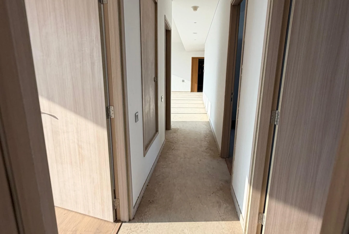 Corridor connecting the bedrooms with wooden doors in 5 BHK at Rustomjee Crown, Prabhadevi
