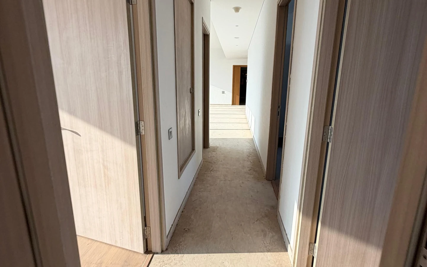 Corridor connecting the bedrooms with wooden doors in 5 BHK at Rustomjee Crown, Prabhadevi